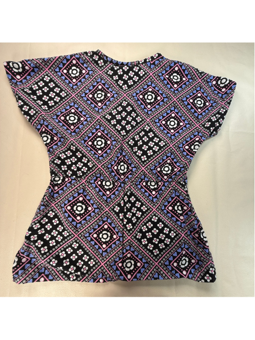 UA Scrubs women’s scrub top in size Large featuring a bright floral and heart